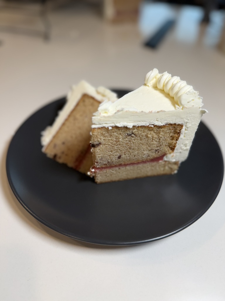 Strawberry Fields cake slices with strawberry filling and vanilla buttercream.